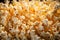 Popcorn kernels burst on a background, forming a textured and appetizing display