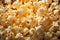 Popcorn kernels burst on a background, forming a textured and appetizing display