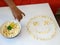 Popcorn laid out in the shape of a smiley, on a white background