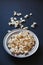 Popcorn in a metallic plate on a dark painted matte surface