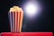 Popcorn over cinema light background, movie concept