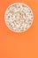 Popcorn in a paper cup on an orange background from the top. Flat lay. Movie in the cinema