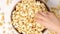 Popcorn tossed in a wooden bowl on a white background. Slow Motion video. Close up top view