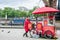 Popcorn vendor with red tricycle in London on the shore of Thames river