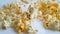 Popcorn on a white background hand drops, slow-motion shot