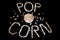 Popped Popcorn maize kernels and shaped in the word â€˜popcornâ€™