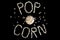 Popped Popcorn maize kernels and shaped in the word â€˜popcornâ€™