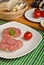 poppy seed bread with salami on a plate