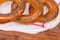 Poppy seed ring-shaped bread rolls on a napkin, fragment