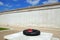 Poppy wreath & a wall of names of the fallen in the inner circle of the Armed Forces Memorial, Alrewas.