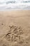 Popular 90s slang phrase You Go Girl written in sand on the beach. Nostalgia concept