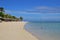 Popular Beach Resort at Le Morne, Mauritius, East Africa with waving palm trees and sunbathing hut