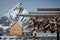 Popular cabin with sharp mountain in the background, blurred. Wooden drying racks with stockfish in the foreground. Usually over t