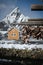 Popular cabin with sharp mountain in the background, blurred. Wooden drying racks with stockfish in the foreground. Usually over t