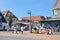 Popular city center with small tourist shops in De Koog on the island Texel in the Netherlands crowded with many visitors on a sun