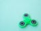 Popular colourful fidget spinner toy on a colored background