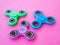 Popular colourful fidget spinner toy on a colored background