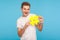 Popular content. Happy funny man in white t-shirt holding big yellow hashtag symbol and smiling