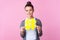 Popular content, promotion! Portrait of trendy brunette teen girl smiling and holding large yellow hashtag. isolated on pink