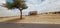 An popular dessert Beautifully built cottage  and lonely tree Building looking away desert nature and sky and clouds