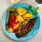 Popular dish of grilled beef Churrasco, potatoes and peppers