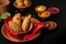 Popular Holi Snack known as Karanji or Gujia is Served on earthen platter. (Holi Concept