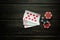 Popular poker game with royal flush winning combination. Cards with chips on a black vintage table in a poker club. Free black