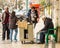 Popular seller of roasted chestnuts and customers, Lisbon, Portugal