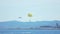 Popular summer resort, people parasailing above sea, plane landing on runway