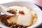 Popular Taiwan gourmet - Dessert of tapioca pearl ball bubble mixed bean curd tofu pudding douhua, dou hua in white bowl,