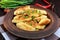 Popular traditional Czech, Hungarian, German dish: potato knedli dumplings with slices of fried bacon, spicy red pepper and gree