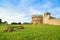 Populonia medieval village landmark, bench, city walls and tower. Tuscany, Italy.