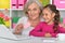 Porait of happy grandmother and granddaughter shopping online