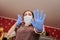 Poratrait of a woman in rubber gloves and a medical mask, in horror, defends her hands. Bottom view. Grocery store, small business