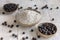 Porcalain bowls of black chickpea flour and beans closeup