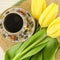 Porcelain coffee cup with yellow tulip flowers