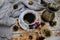 Porcelain cup of black coffee and coffeepot on the rustic background with winter decoration.