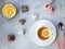 Porcelain cup of green tea with lemon and various sweets on a gray background with flowers. spring time.