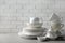 Porcelain dishware on table and white wall background