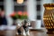 porcelain dog stands on a wooden table. blurred room background.