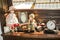 Porcelain dolls, old photographs and vintage clock on wooden shelf