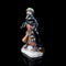 Porcelain figurine . antique figurine of a robber on a black  background.