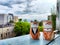 Porcelain figurines of couple of cats in men's and women's costumes on a high balcony against the backdrop of