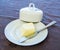 Porcelain plate with cover and silver knife with butter on a decorated cover