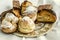 Porcelain plate with pieces of different cakes, baklava, eclairs and traditional Armenian `Gata` cookies of puff pastry on a white