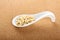 Porcelain spoon with seeds pine nuts