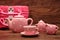 A porcelain spotted tea set with a pink basket