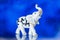 Porcelain statuette, porcelain statuette of the elephant on a blue background
