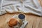 Porcelain teacup with waffles on cotton napkin on a rustic wooden background, top view, close-up