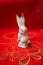 Porcelain white bunny rabbit on red textile material